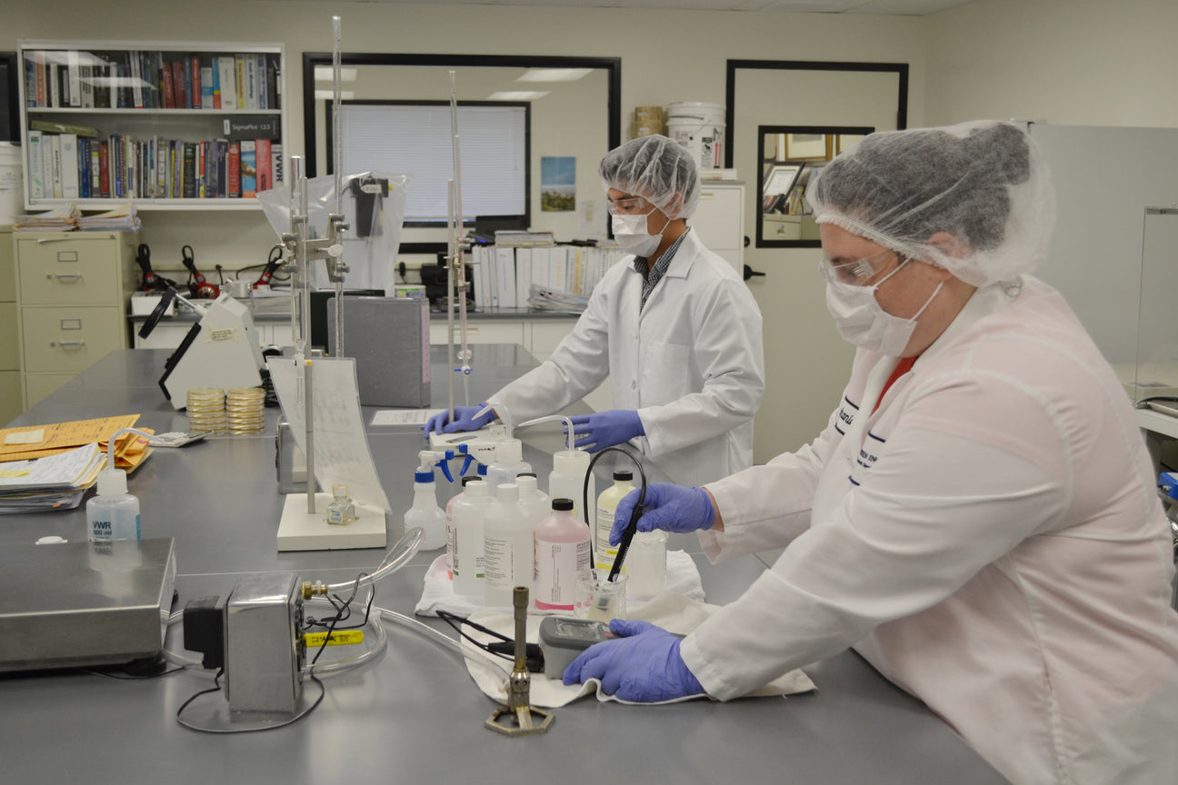 Two Natren team members working at a laboratory bench inside the Natren laboratory